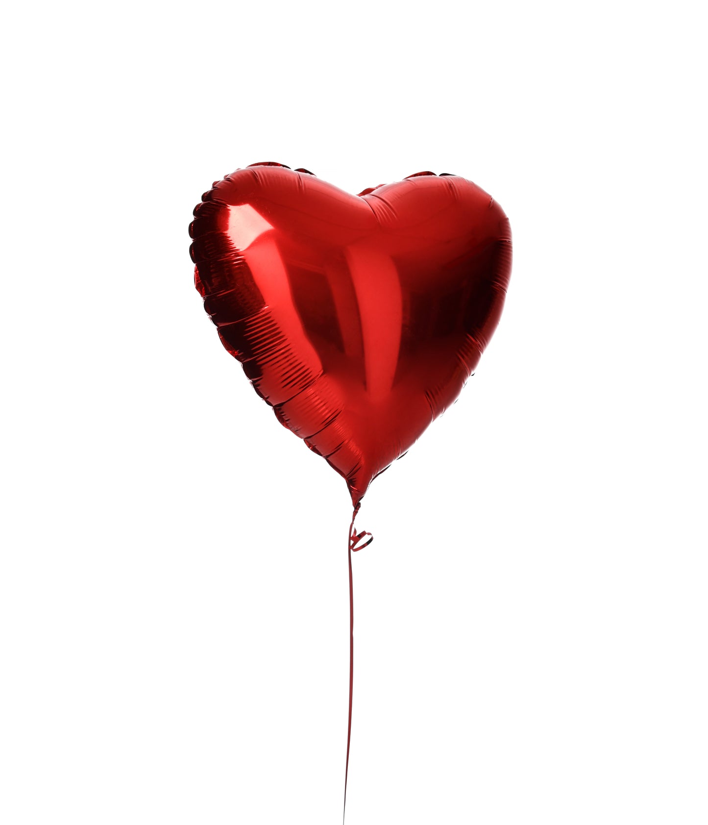 Red heart-shaped foil balloon on a string against a plain white background