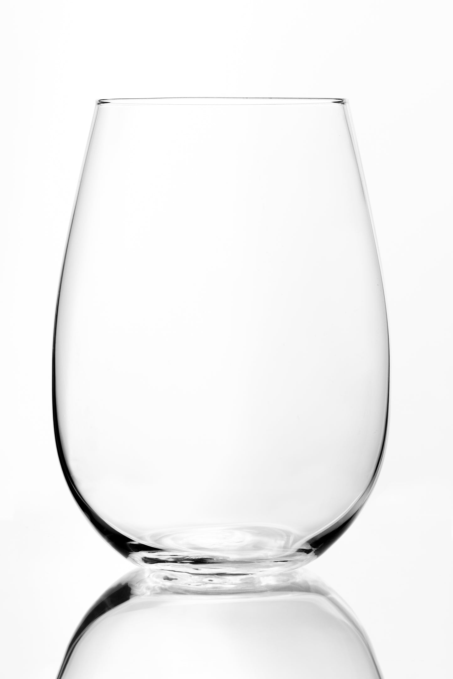Empty clear vase with a rounded body and narrow base, photographed on a white background